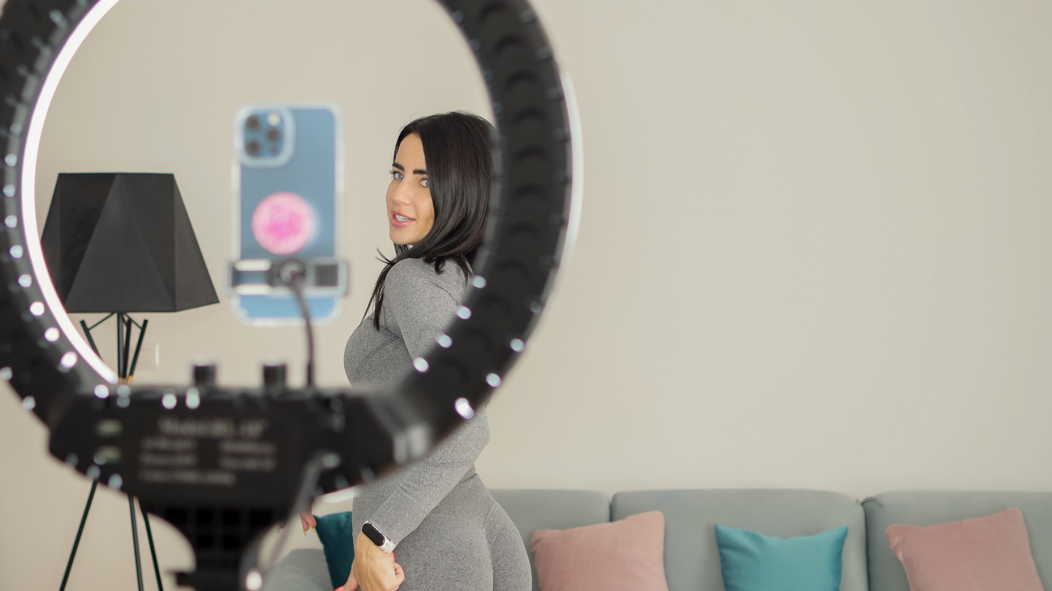 OnlyFans creator filming content with ring light - Climaxx Media management service